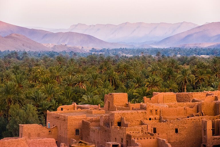 Some stone buildings in a desert-like area.