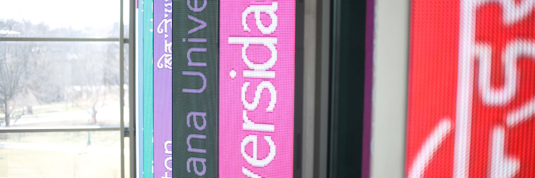 The digital blades in the HLS atrium display phrases in foreign languages.